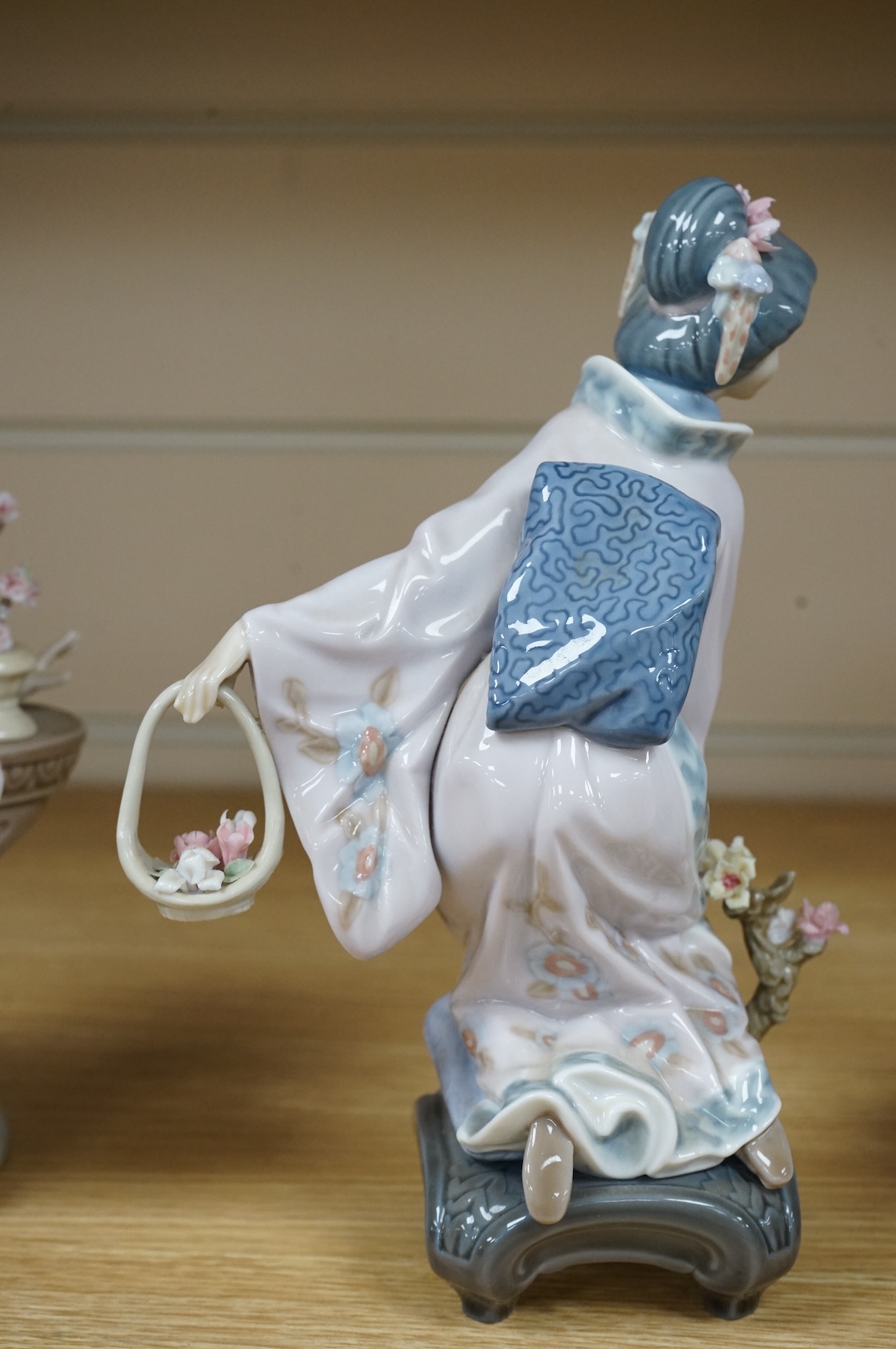 Three Lladro models of seated Geisha. Tallest 23cm